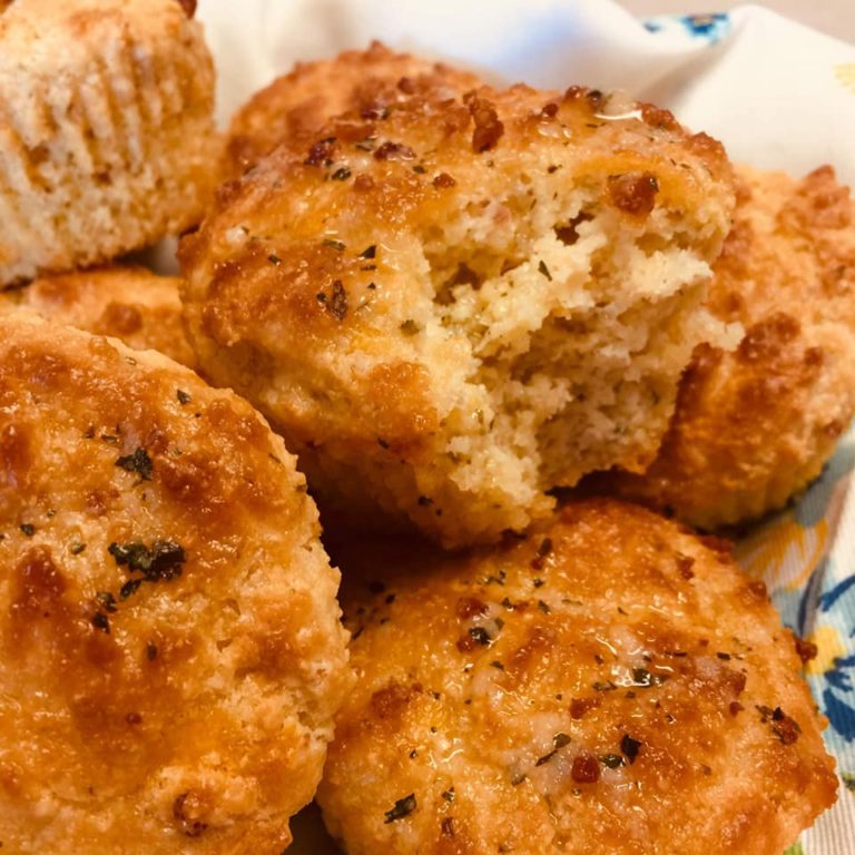 bite out of a garlic biscuits with more biscuits around it