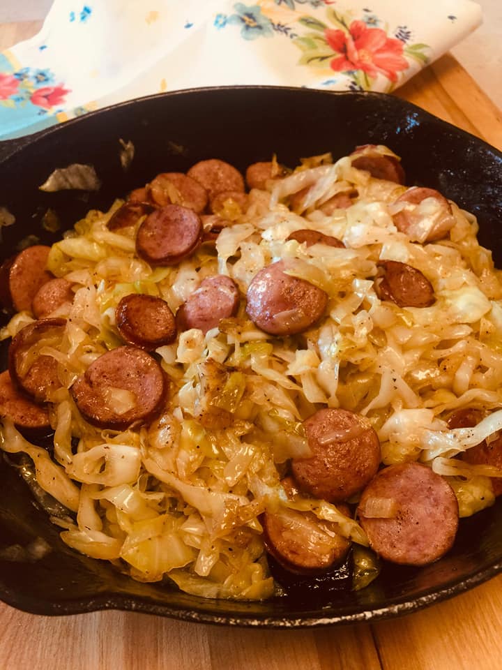 cast iron skillet filled with summer sausage and cabbage stir fry