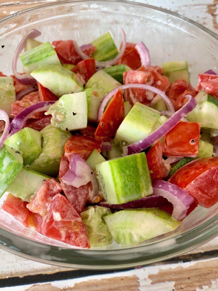 cucumber tomato salad in a glass bowl