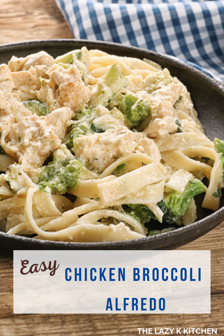 black skillet of chicken alfredo noodles, broccoli on a wood table