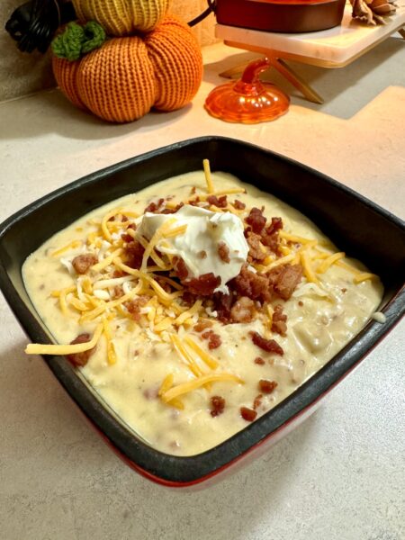 loaded potato soup in a black bowl
