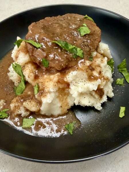 crockpot salisbury steak in a black bowl