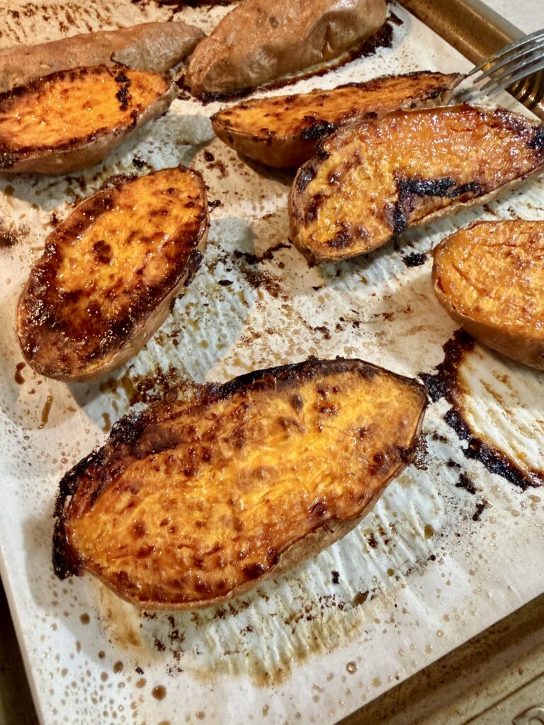 baked sweet potatoes on a baking sheet