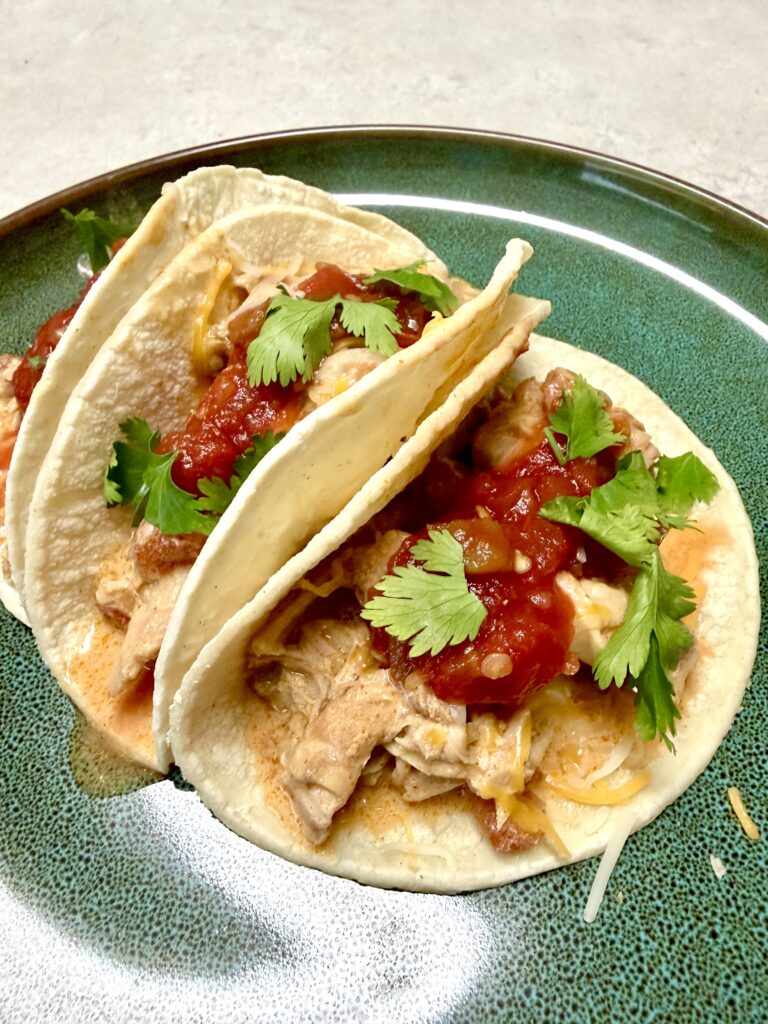 green plate of chicken tacos