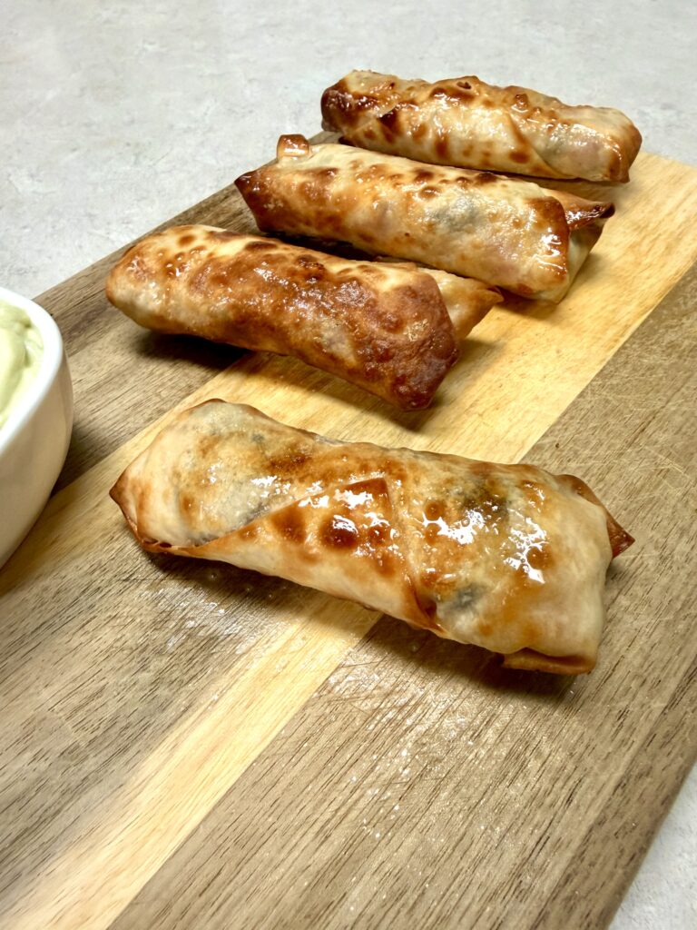 Southwest egg rolls on a wooden cutting board