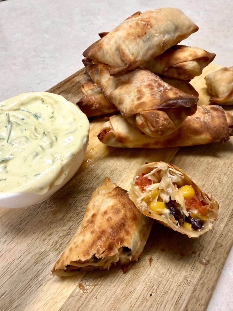 Southwest egg rolls on a wooden cutting board