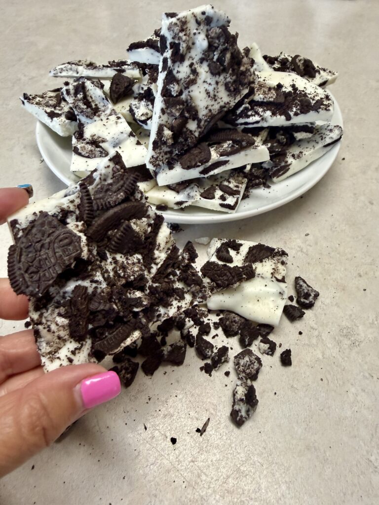 Picture of a hand holding cookie and cream almond bark