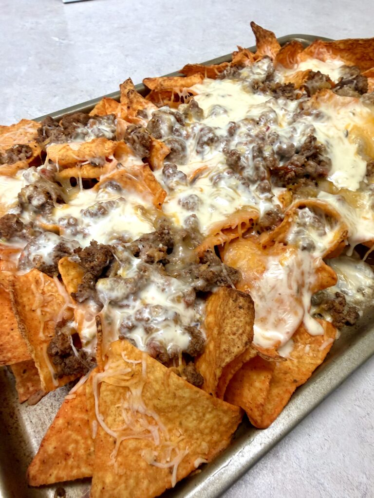 Picture of sheet pan nachos on a baking sheet pan.