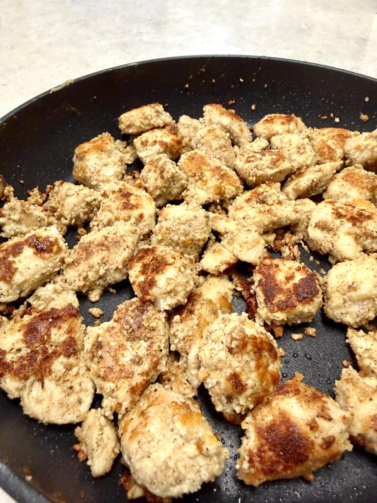 Picture of garlic parmesan chicken bites in a skillet.