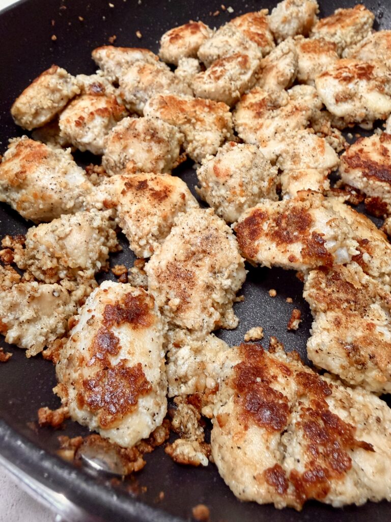 Picture of garlic parmesan chicken bites in a skillet.