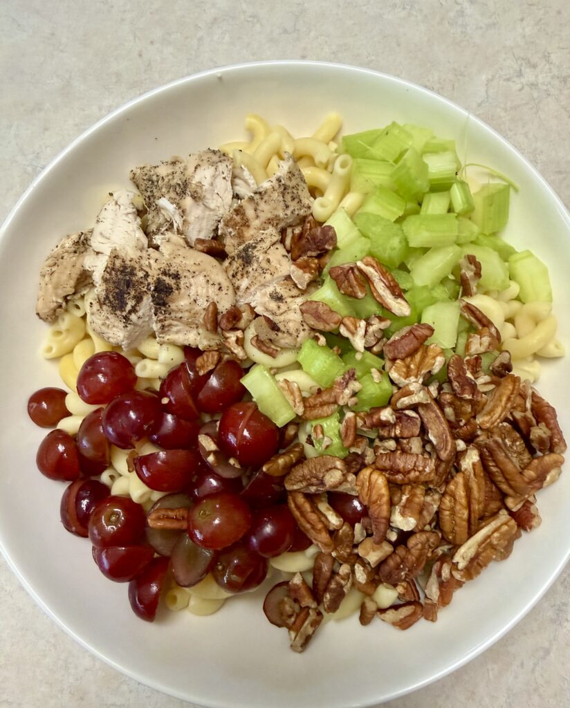 Picture of poppyseed chicken salad in a white bowl.