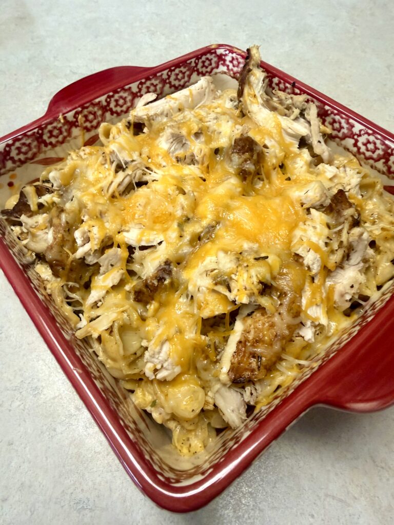 Picture of ranch chicken mac and cheese in a red baking dish.