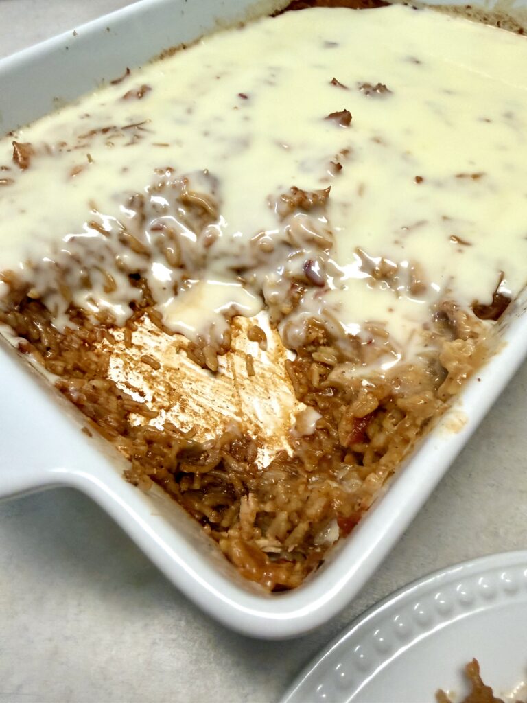 Picture of chicken fajita queso bake in a white baking dish.