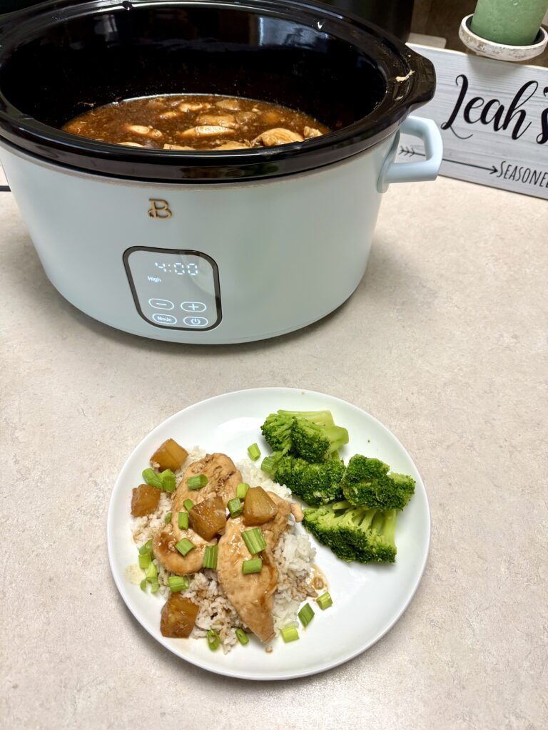 chicken teriyaki and broccoli on a white plate and chicken in a crockpot