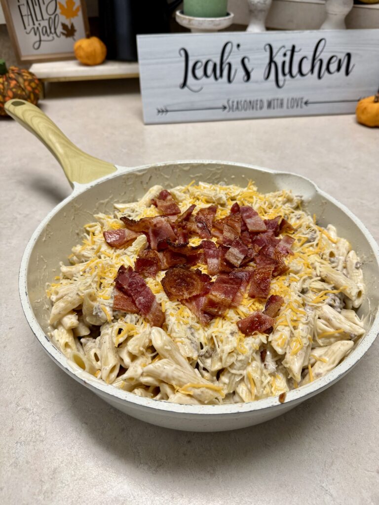 bacon cheeseburger alfredo pasta in a white skillet