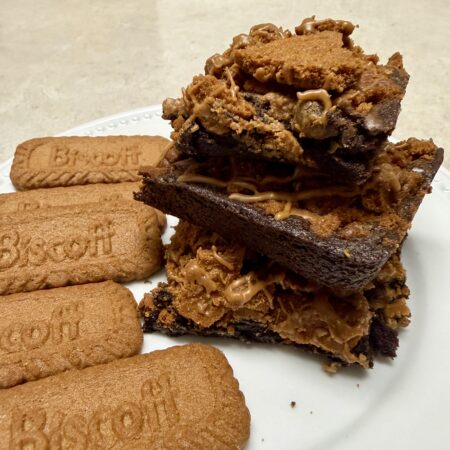 Biscoff brownies stacked on a white plate