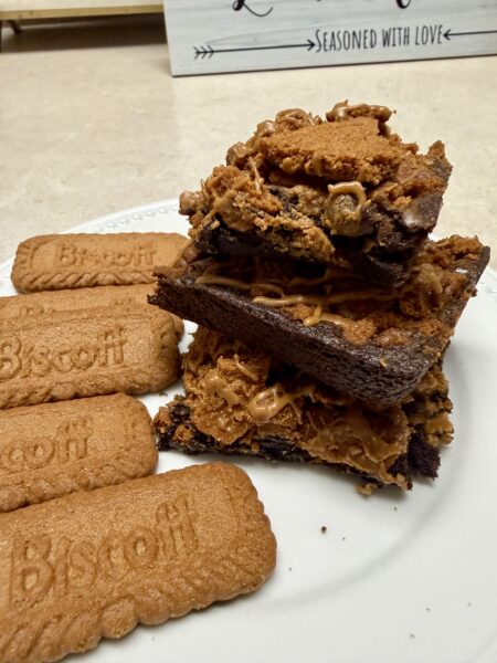 Biscoff brownies stacked on a white plate