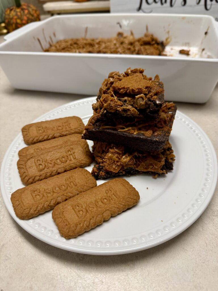 Biscoff brownies stacked on a white plate