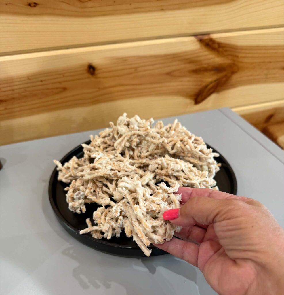 a hand holding a white chocolate haystack cookie