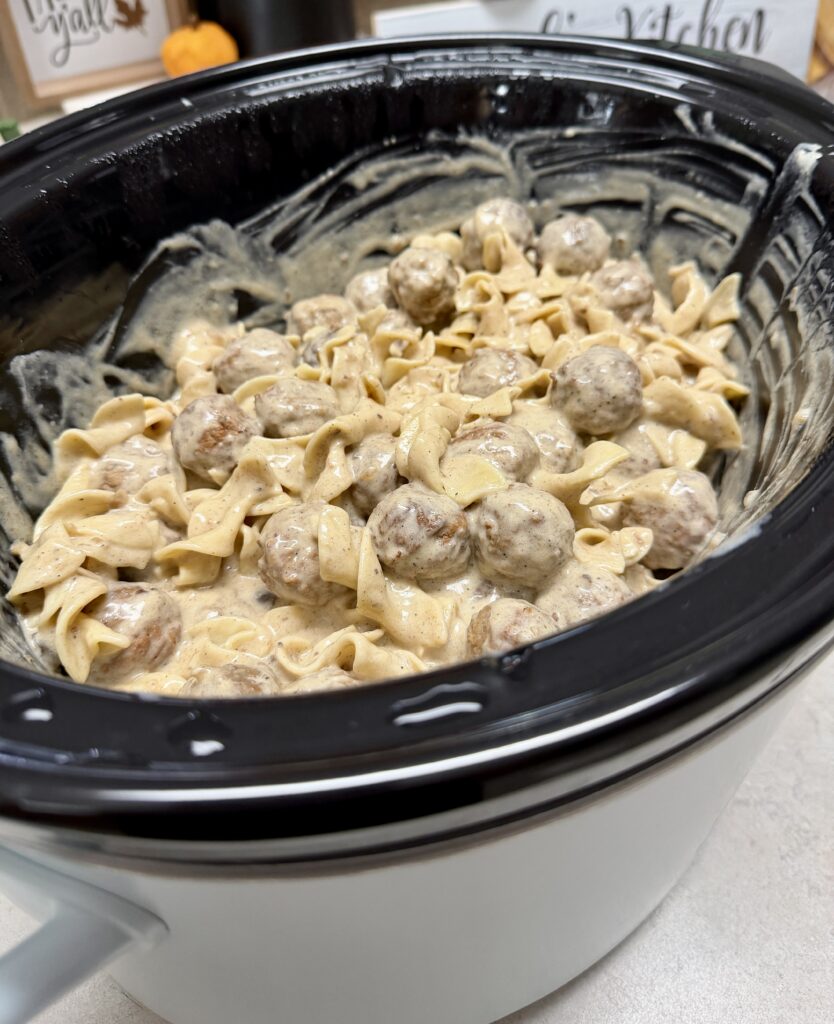 crockpot filled with swedish meatballs and noodles